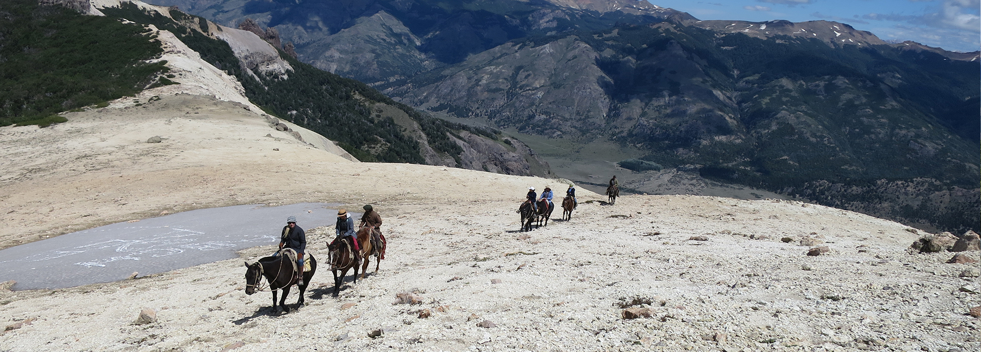 Tourists riding through Patagonia on a bucket list travel horseriding safari through Patagonia