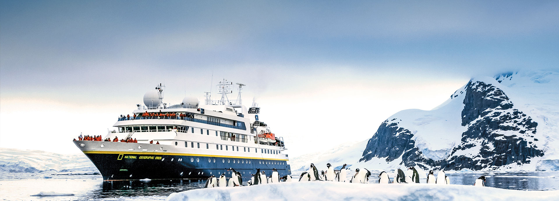 An Antarctic cruise passing an ice floe with penguins, offering a magical winter vacation