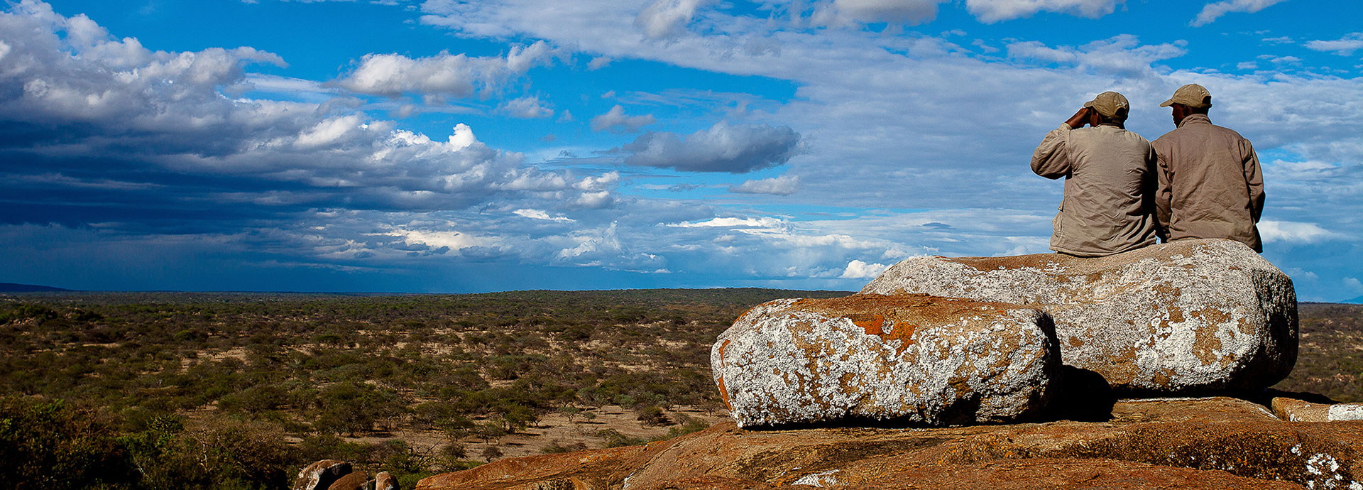 Couple looks to the horizon on safari in Africa