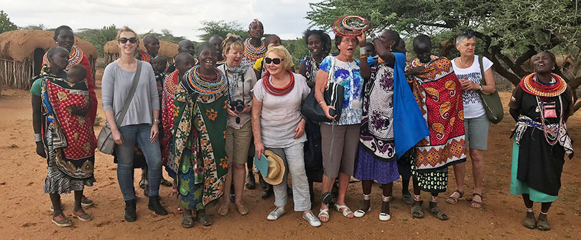 Tourists dance with Maasai women in Kenya
