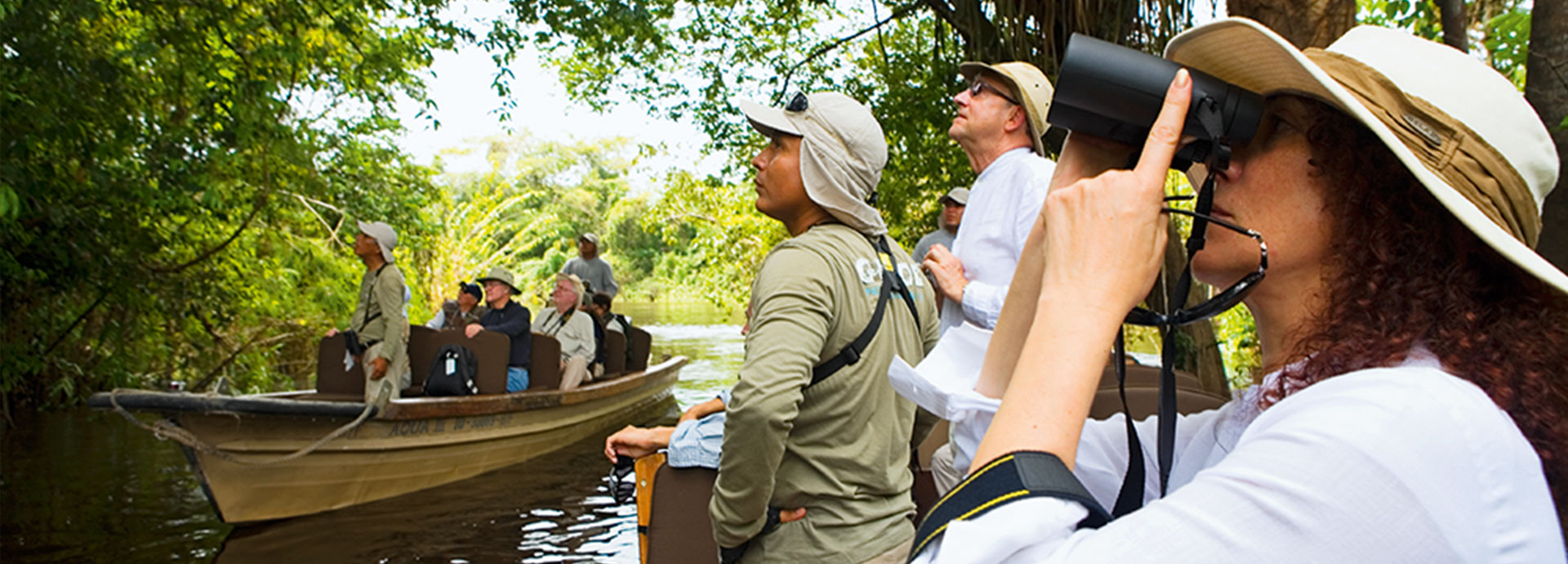 Tourists with an expert naturalist viewing wildlife on a luxury cruise on the Amazon River