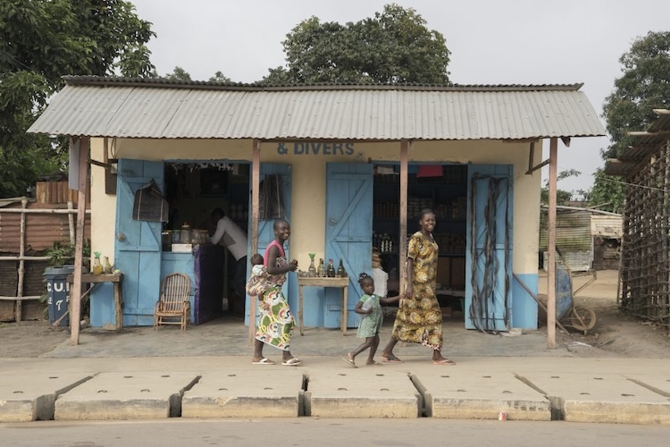 Women walking through Mbomo Village