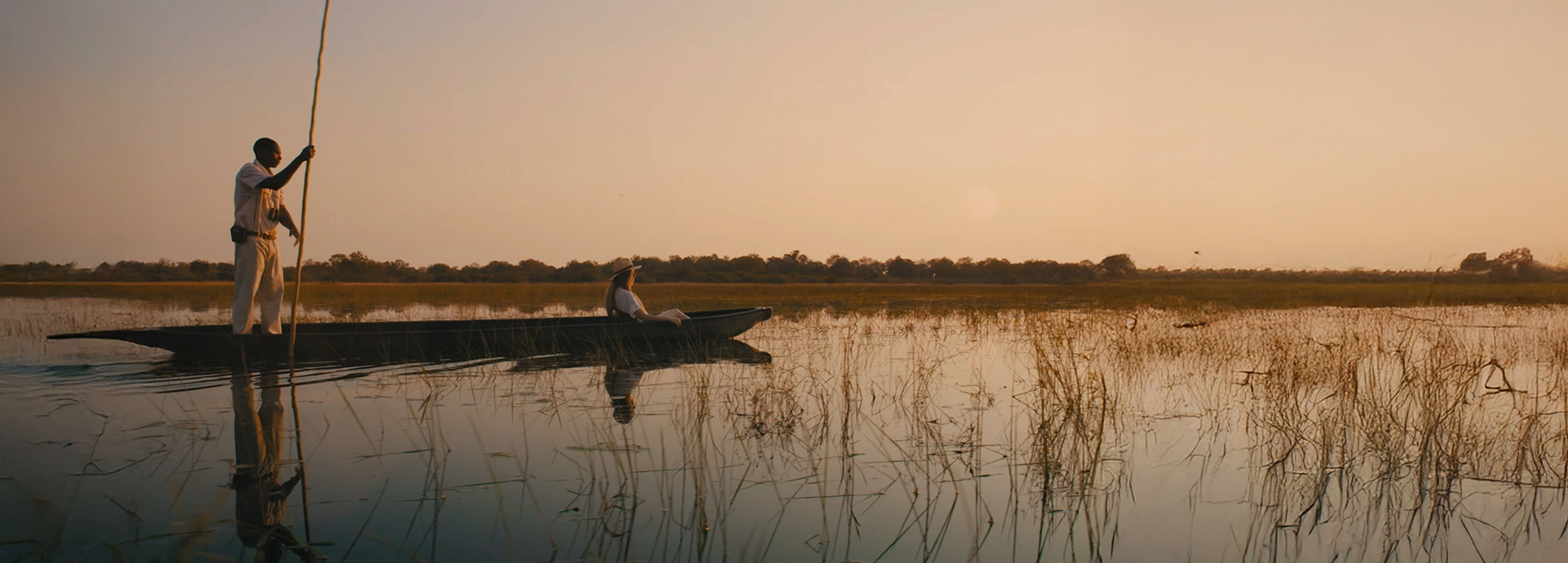 Woman taking a mokoro ride through the Okavango Delta with an expert guide.