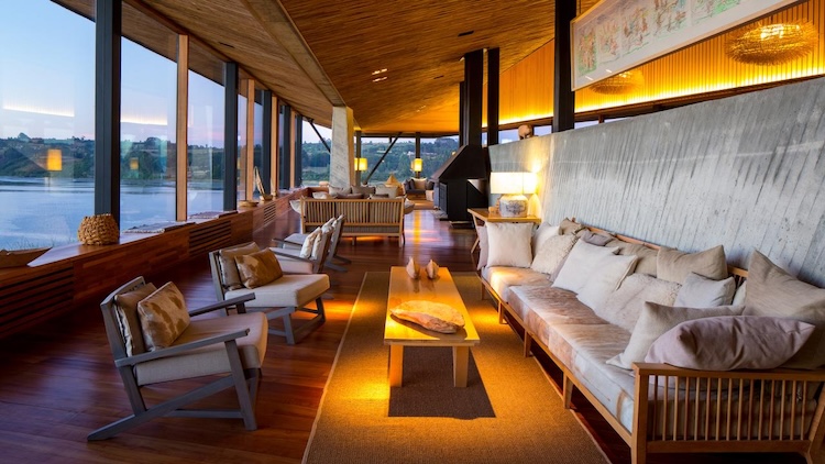 Cosy lounge area at Refugia Lodge featuring wood finishes and panoramic windows