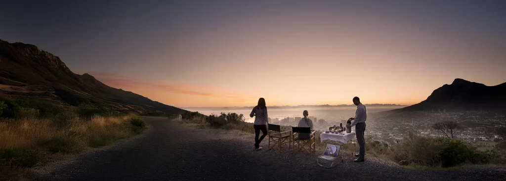 Guests enjoying sunrise breakfast overlooking Cape Town and Table Mountain from Lions Head.