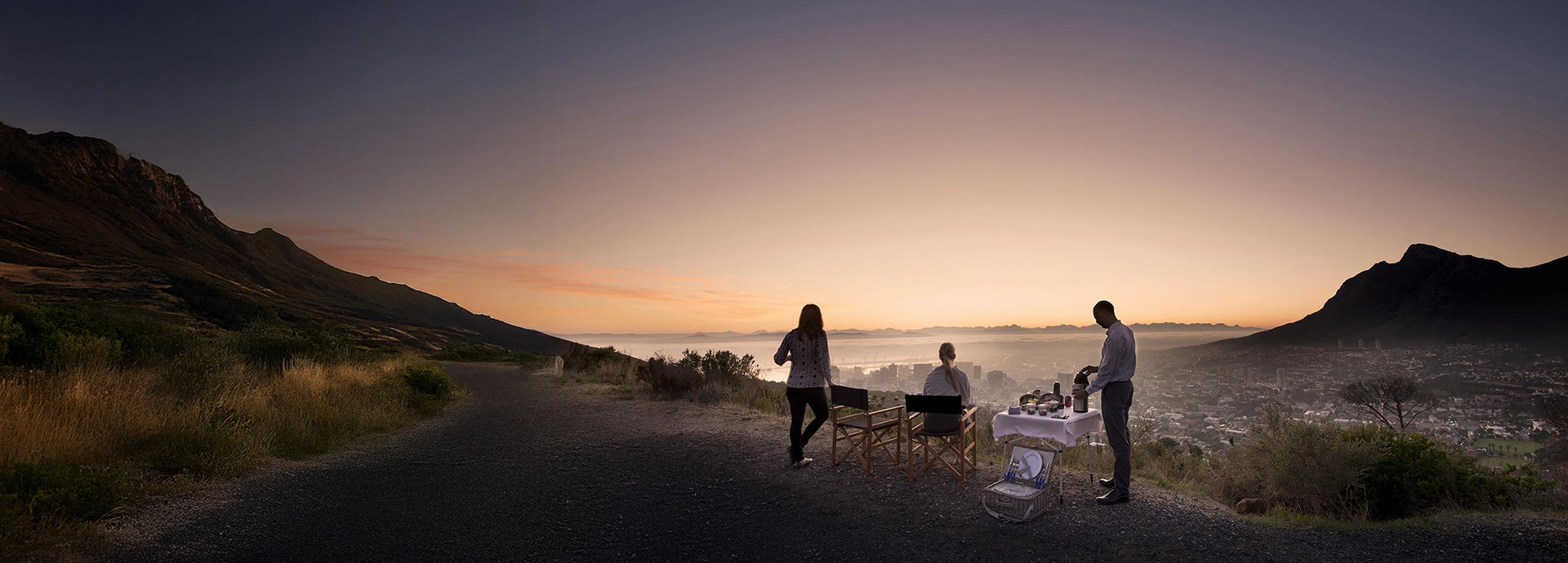 Guests enjoying sunrise breakfast overlooking Cape Town and Table Mountain from Lions Head.