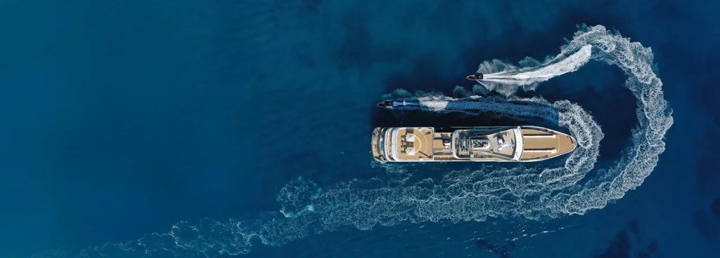 Aqua Lares expedition cruise vessel being circled by two zodiac tenders while in the Seychelles.