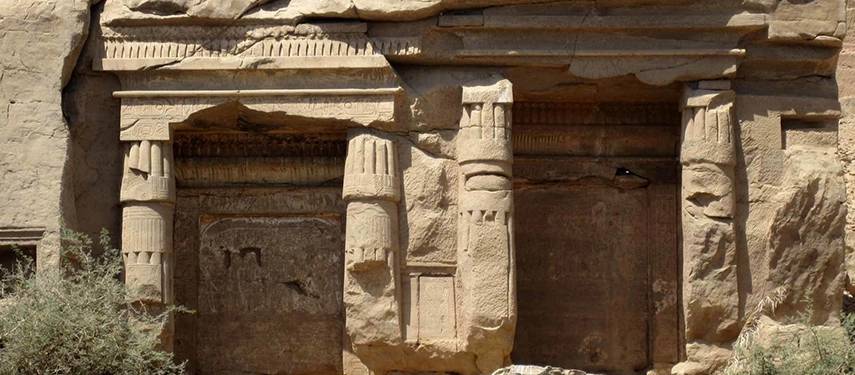 Ancient sandstone carvings emerge from a rugged cliff face, marking the historic quarries of Gebel Silsileh.