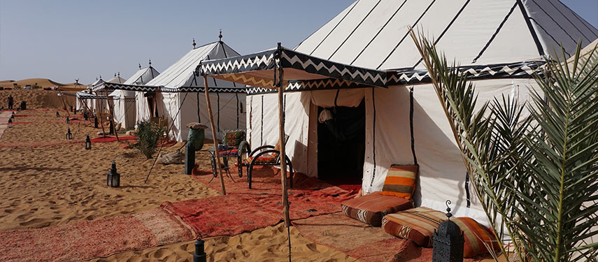 Elegant white tents in the Erg Chebi Desert At Merzouga Luxury Desert Camp