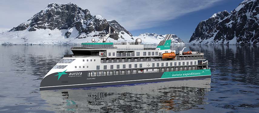 Aurora Expeditions’ ship Greg Mortimer sailing through icy Arctic waters with snow-covered mountains in the background on the Jewels of the Arctic itinerary.