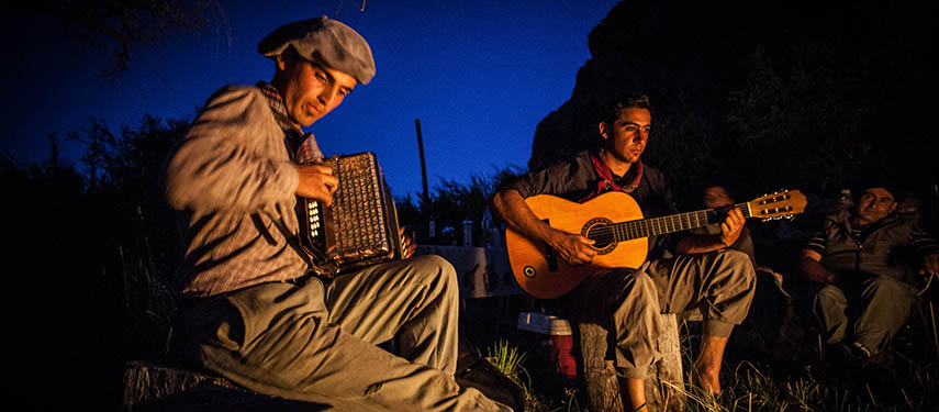 Sit outside in the countryside and play music while at an Argentine estancia such as at Los Potreros