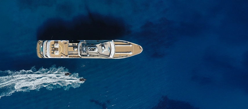 Aerial shot of Aqua Lares cruising deep blue waters accompanied by two tenders.