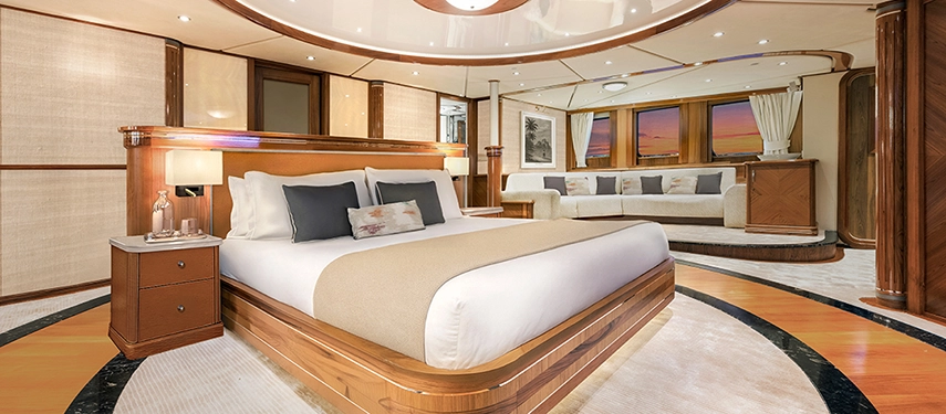 Spacious owner’s suite with panoramic windows, a king bed and refined timber detailing.