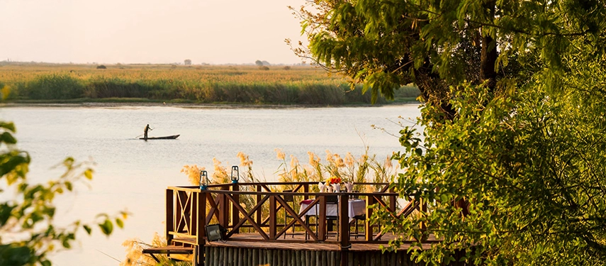 Elevated deck at Chobe Marina Lodge set for riverside dining at sunset