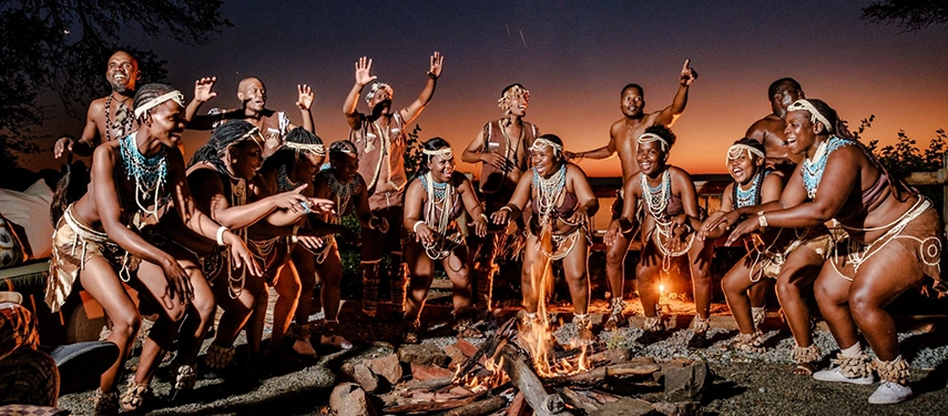 Traditional dancers performing at night by fire at Chobe Marina Lodge