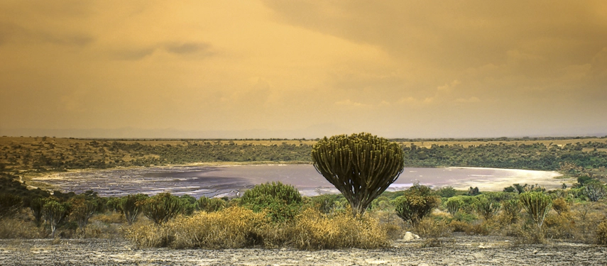 Dramatic view of salt crater lake in Queen Elizabeth National Park under ochre sky