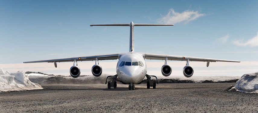 A jet plane amongst snowdrifts waiting to fly passengers to Antarctica