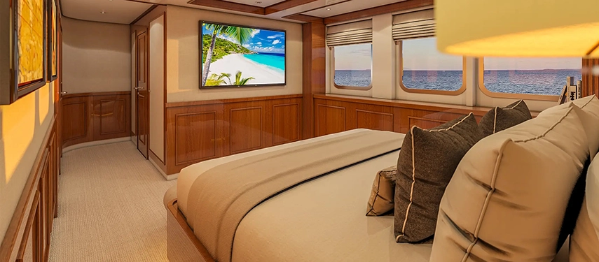 Luxurious suite with a king bed, ocean-view windows and elegant timber accents.