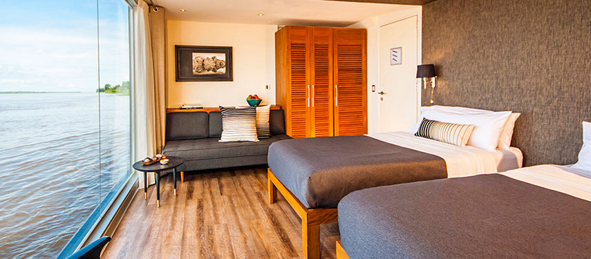 Luxurious twin berth cabin aboard an Amazon River cruise with stunning views
