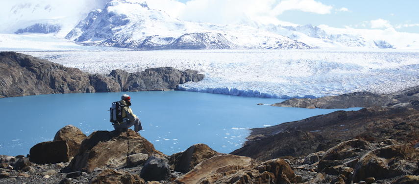 Man viewing a glacier across a lake in Argentina