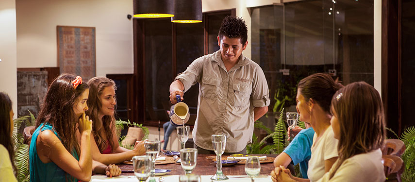 Guests are served drinks in the al fresco dining area of Galápagos Safari Camp on Santa Cruz Island
