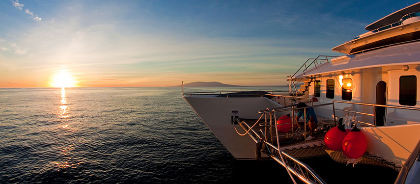 Watch the sunset onboard the MC Cormorant catamaran and sail around the Galapagos Islands