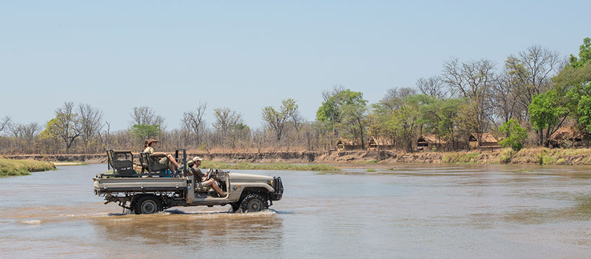 Drive over rivers in search of local wildlife on a game drive at Mwaleshi Camp in Zambia
