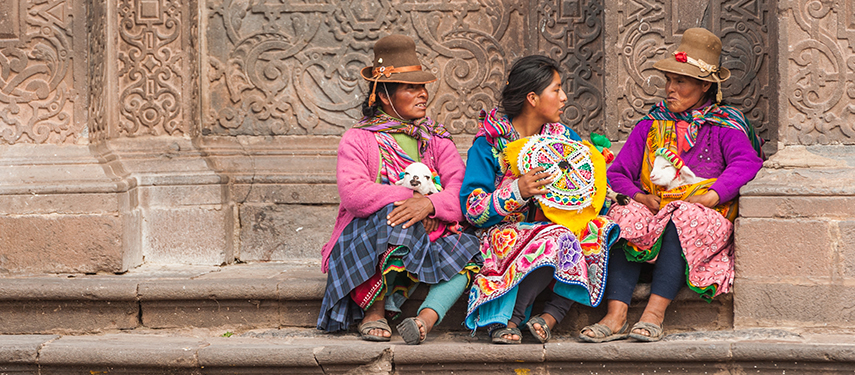 Women in traditional clothes on a street in Cusco, Peru