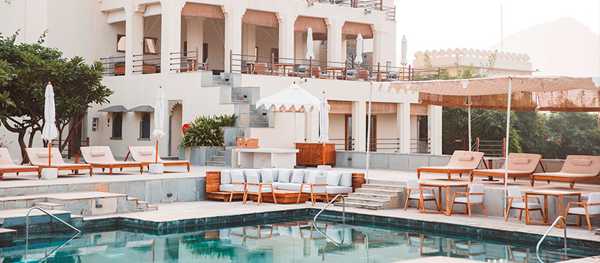 The pool creates a soothing oasis with the stunning grounds of the Devigarh Palace