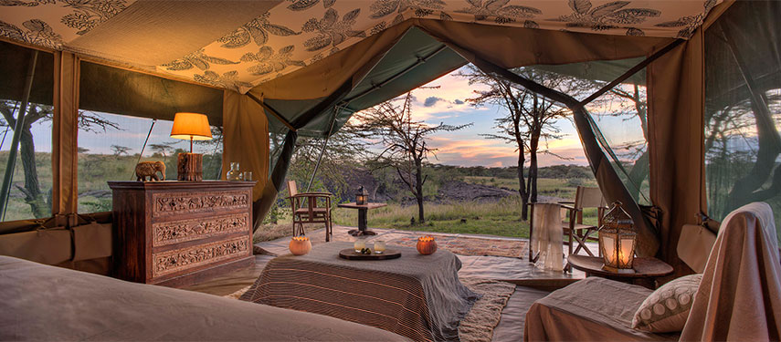 Room views over the waterhole at Richard's Camp in the Mara North Conservancy