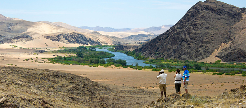 Safari guests overlook the Serra Cafema Valley, nestled inbetween Angola and Namibia