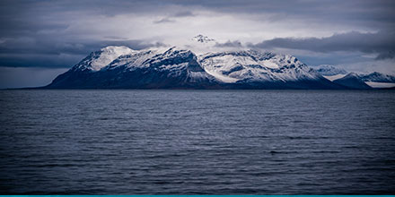 The wintery mountains of Svalbard viewed across the Arctic sea